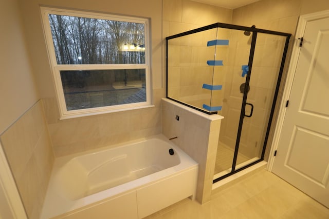 full bathroom featuring a stall shower and a bath