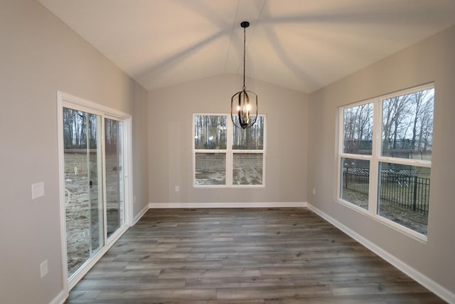 unfurnished dining area featuring a chandelier, dark wood-type flooring, and lofted ceiling