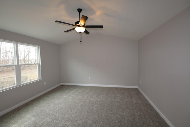 unfurnished room featuring baseboards, carpet, lofted ceiling, and a ceiling fan