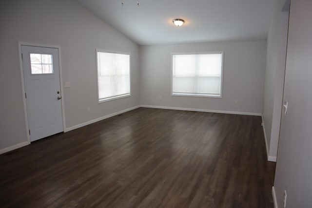 foyer entrance featuring dark hardwood / wood-style floors and vaulted ceiling