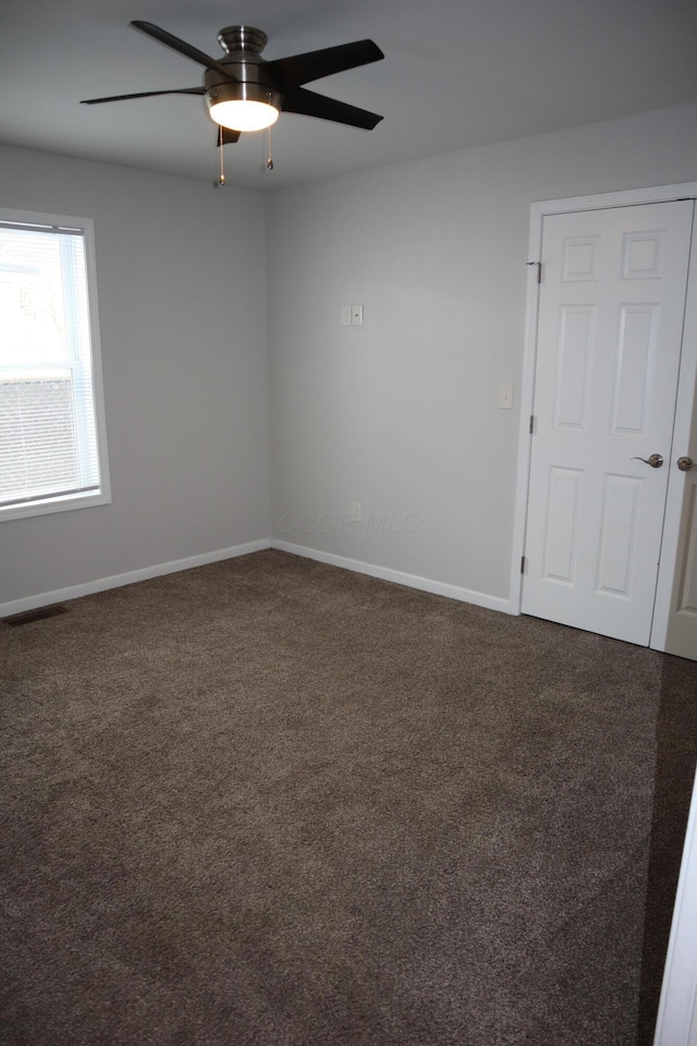 carpeted empty room with ceiling fan