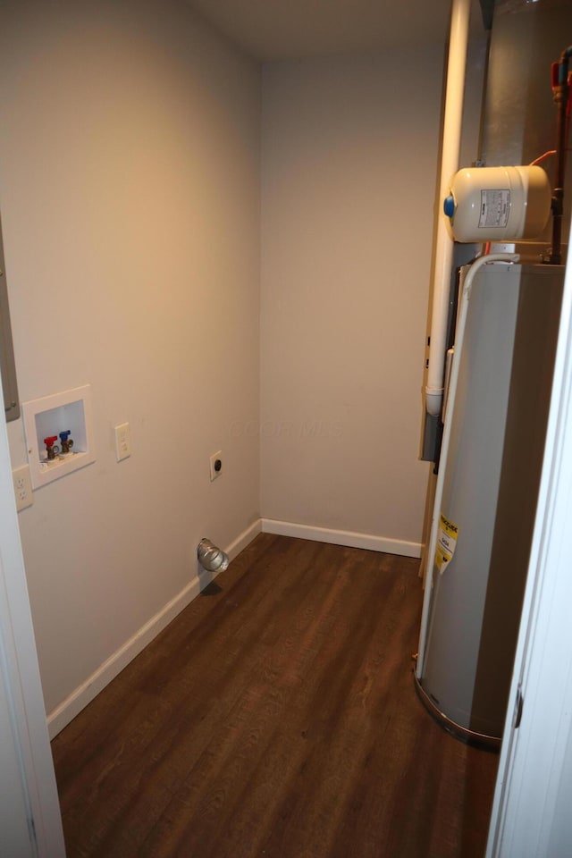 washroom with dark hardwood / wood-style floors, hookup for an electric dryer, hookup for a washing machine, and water heater