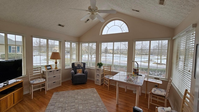 sunroom featuring ceiling fan and lofted ceiling