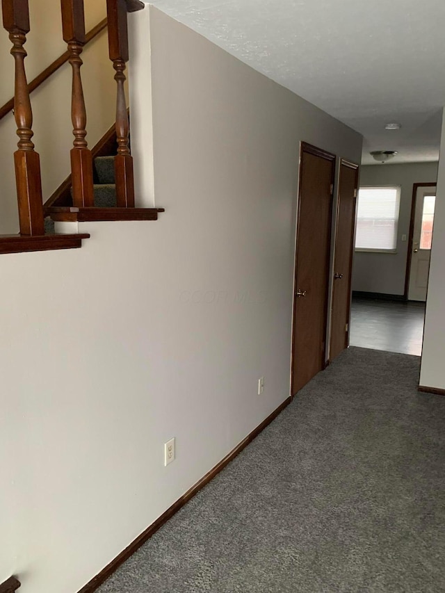 unfurnished room featuring dark colored carpet