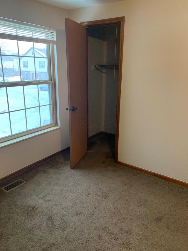 unfurnished bedroom featuring carpet flooring and a closet