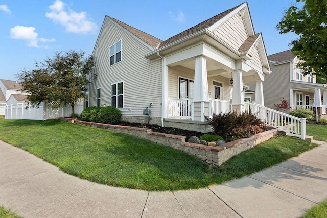 view of front of home with a porch and a front yard