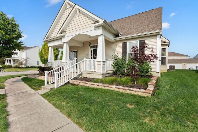 view of front of property with a front yard, a porch, and cooling unit