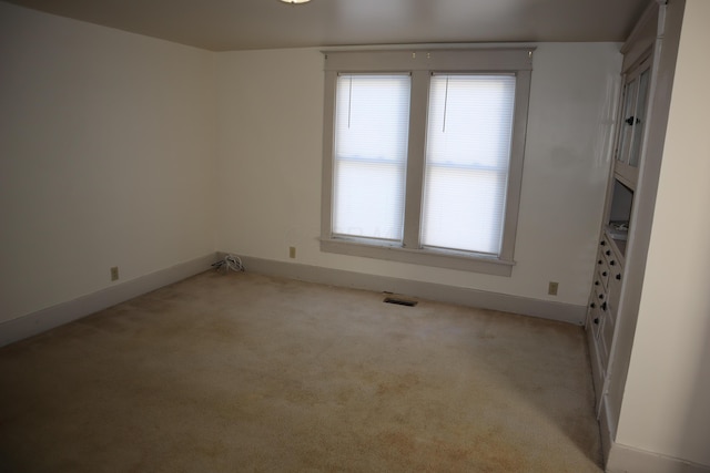 spare room with light colored carpet