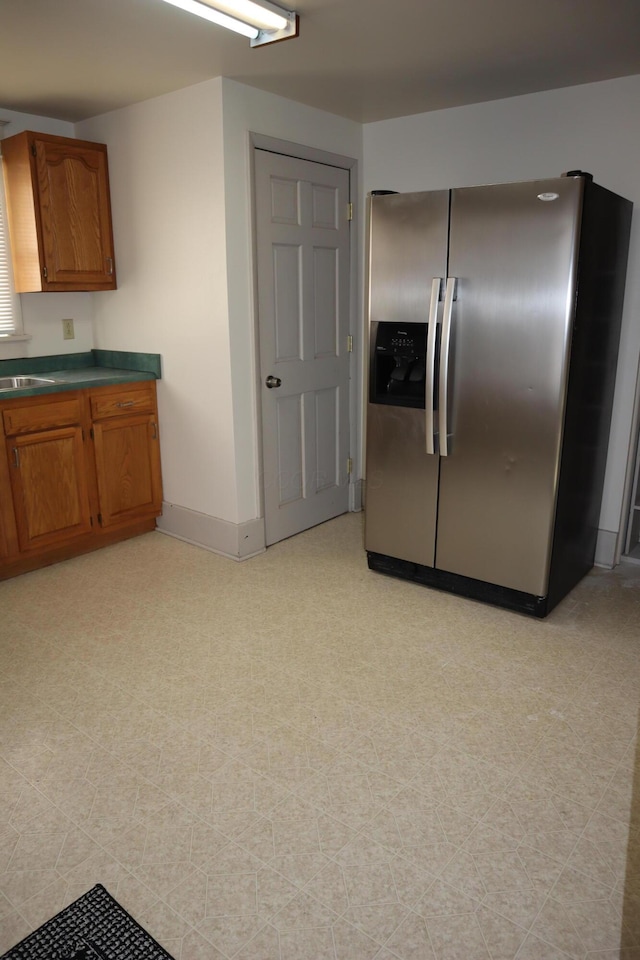 kitchen featuring sink and stainless steel fridge with ice dispenser