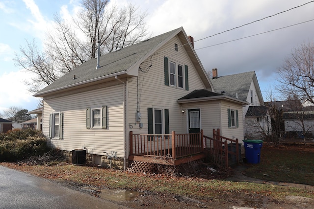 back of property featuring cooling unit and a wooden deck