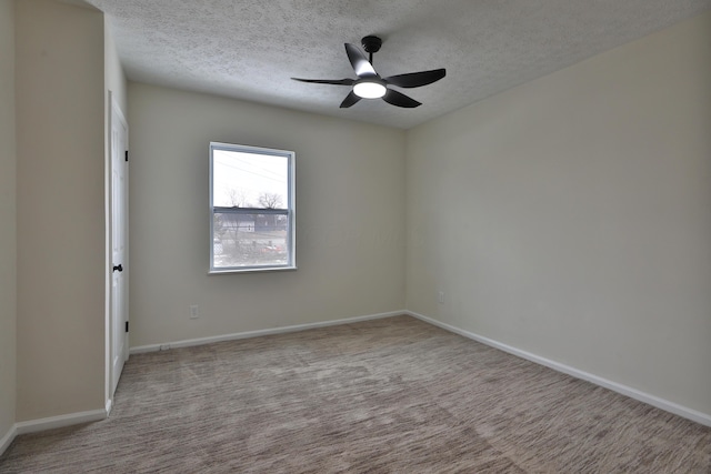 unfurnished room with ceiling fan, light colored carpet, and a textured ceiling