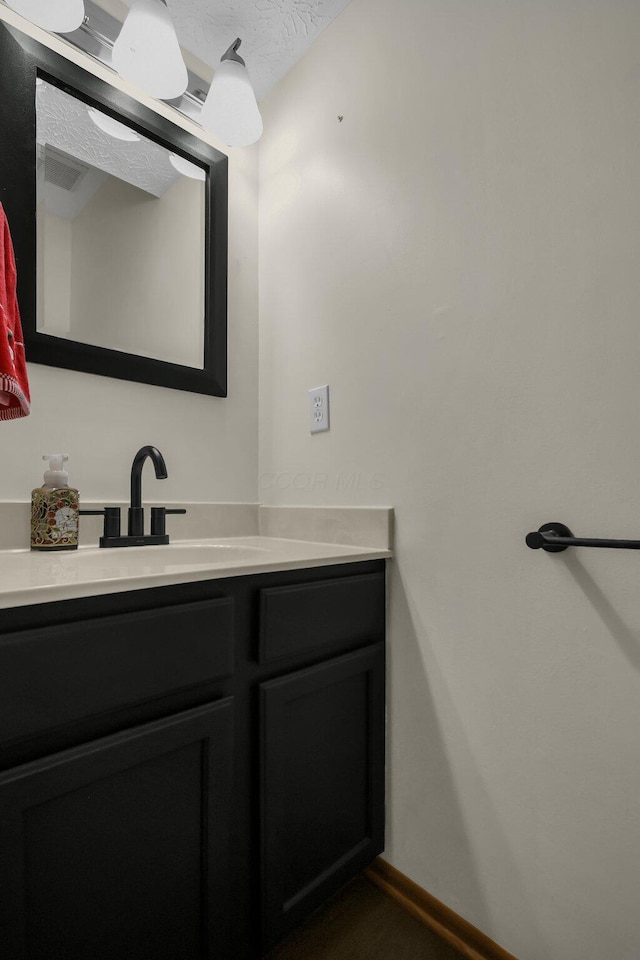 bathroom with vanity and a textured ceiling