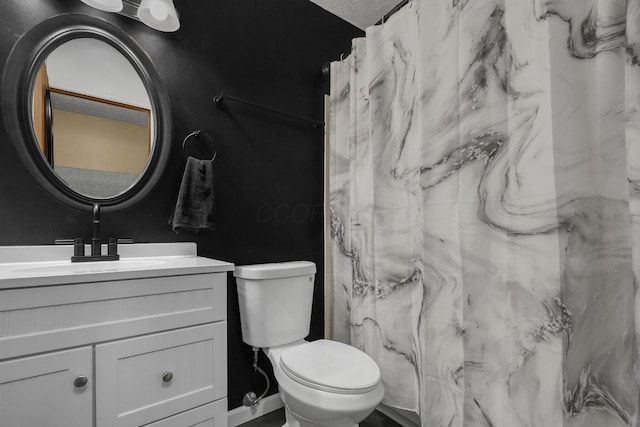 bathroom featuring vanity, curtained shower, toilet, and a textured ceiling