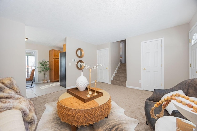 living room featuring a textured ceiling and light carpet