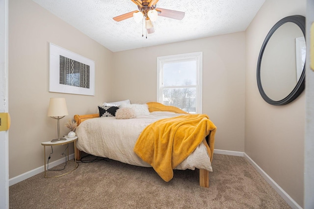 carpeted bedroom with a textured ceiling and ceiling fan