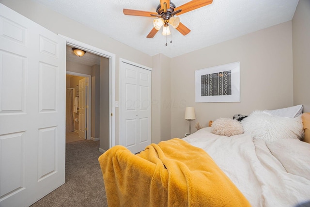 carpeted bedroom featuring ceiling fan and a textured ceiling