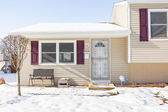 view of snow covered property entrance