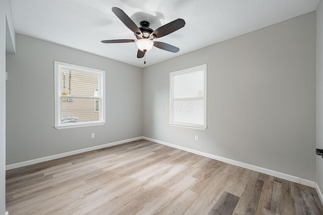 unfurnished room with light hardwood / wood-style floors, ceiling fan, and a textured ceiling