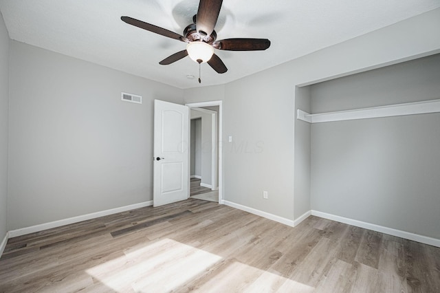 unfurnished bedroom with ceiling fan, light hardwood / wood-style flooring, and a closet