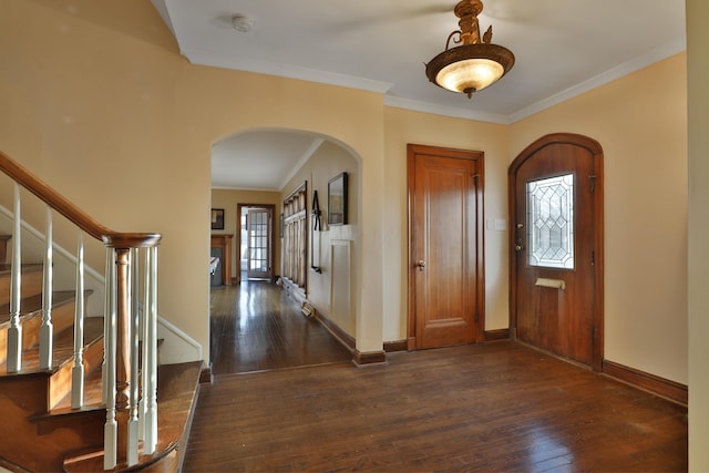 entrance foyer with dark wood-type flooring and ornamental molding