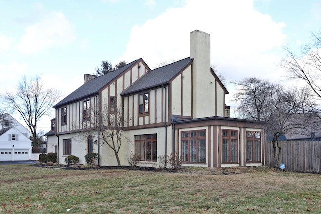 rear view of house with a yard and a sunroom