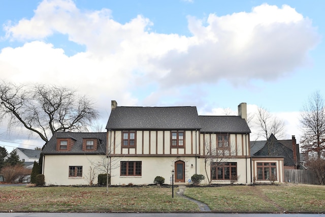 view of front of house with cooling unit and a front lawn