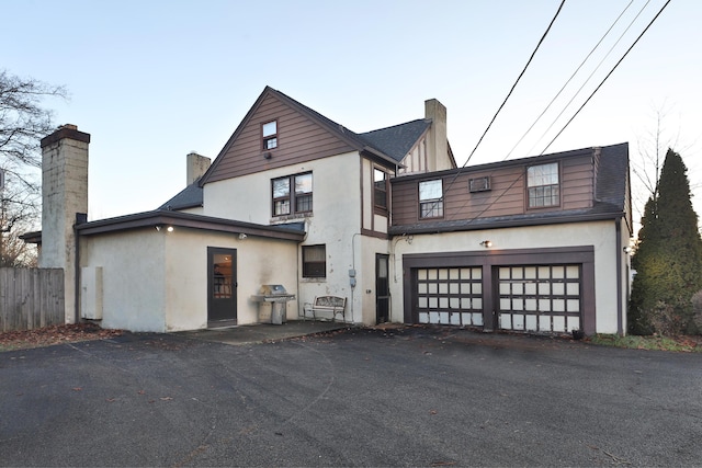 back of house with a garage