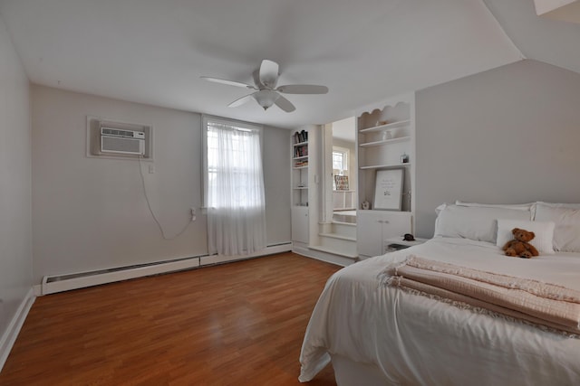 bedroom with a baseboard heating unit, hardwood / wood-style flooring, a wall mounted AC, and ceiling fan