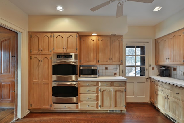 kitchen with appliances with stainless steel finishes, decorative backsplash, ceiling fan, dark wood-type flooring, and light brown cabinets