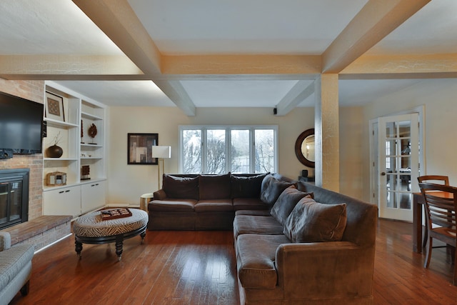 living room with beamed ceiling, dark hardwood / wood-style floors, a fireplace, and built in features