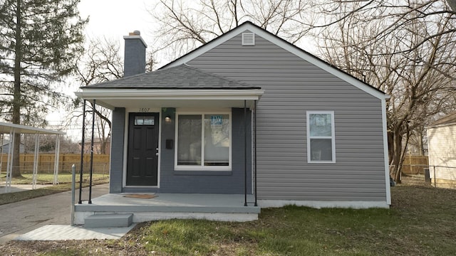 1807 Weiler Ave, Columbus, OH 43207 - rear view of house with fence, a chimney, a shingled roof, and driveway