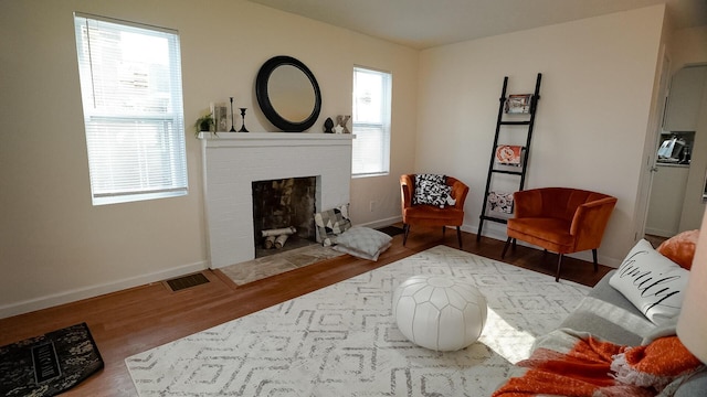 1807 Weiler Ave, Columbus, OH 43207 - living area with wood finished floors, baseboards, and a fireplace