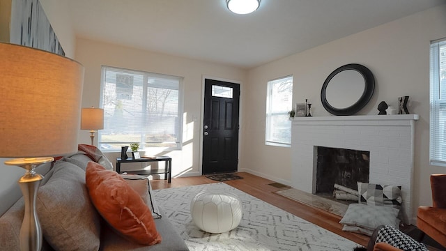1807 Weiler Ave, Columbus, OH 43207 - living area featuring wood finished floors, a fireplace, and baseboards