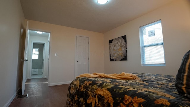 1807 Weiler Ave, Columbus, OH 43207 - bedroom with multiple windows, wood finished floors, and baseboards