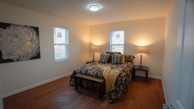 1807 Weiler Ave, Columbus, OH 43207 - bedroom with multiple windows, wood finished floors, and baseboards