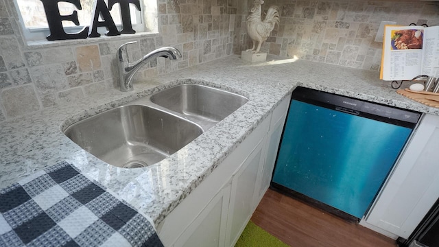 1807 Weiler Ave, Columbus, OH 43207 - kitchen with a sink, dishwashing machine, backsplash, dark wood-type flooring, and white cabinetry