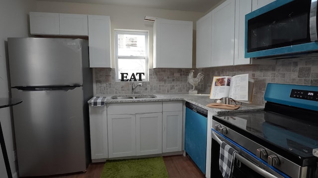 1807 Weiler Ave, Columbus, OH 43207 - kitchen with stainless steel appliances, a sink, and white cabinets