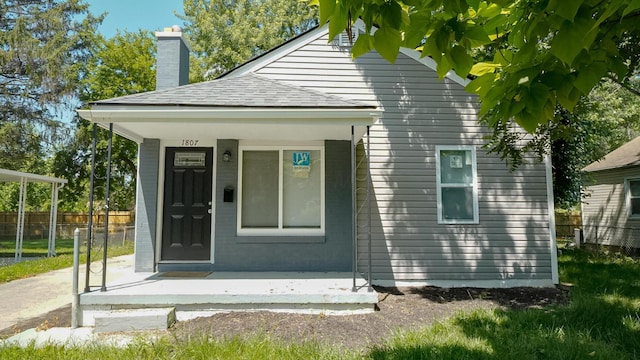 1807 Weiler Ave, Columbus, OH 43207 - entrance to property with covered porch, a chimney, and a shingled roof