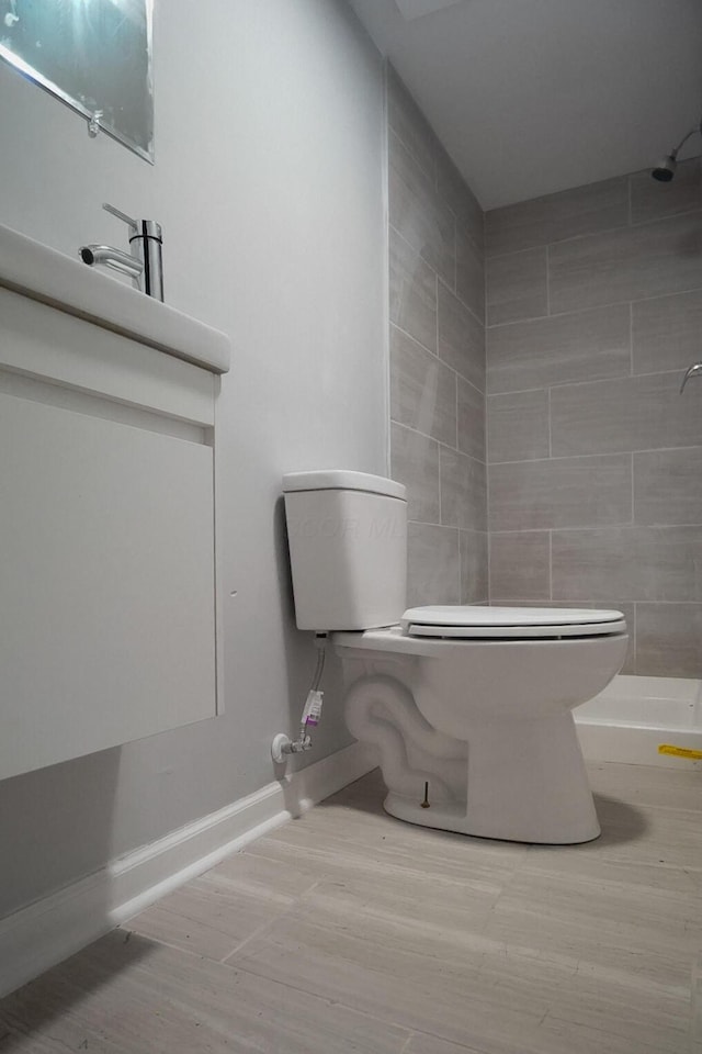 1807 Weiler Ave, Columbus, OH 43207 - full bath with a tile shower, wood finished floors, and vanity