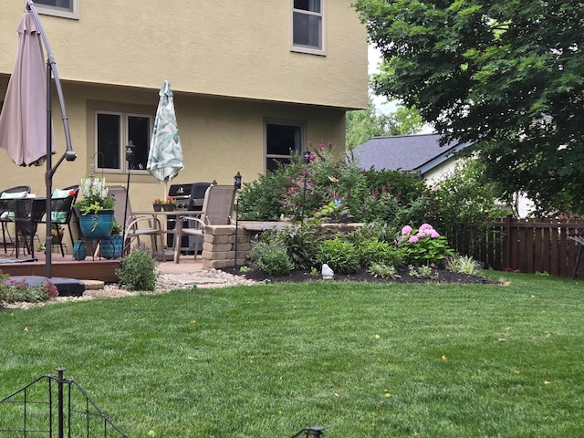 rear view of house featuring a deck and a yard