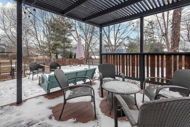 snow covered deck with a pergola