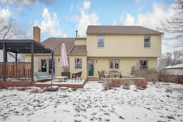 view of snow covered back of property