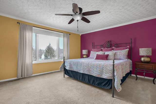 carpeted bedroom with a textured ceiling, ceiling fan, and ornamental molding