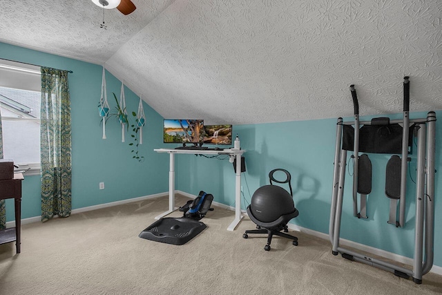 workout room featuring ceiling fan, vaulted ceiling, carpet flooring, and a textured ceiling