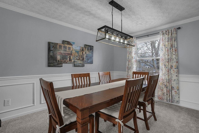 carpeted dining area featuring a textured ceiling and ornamental molding