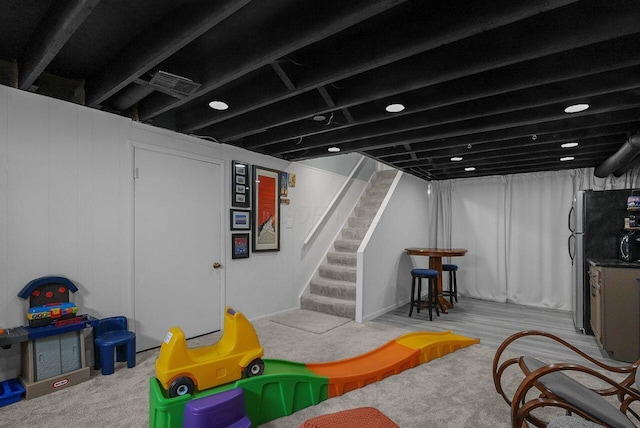 game room featuring light carpet