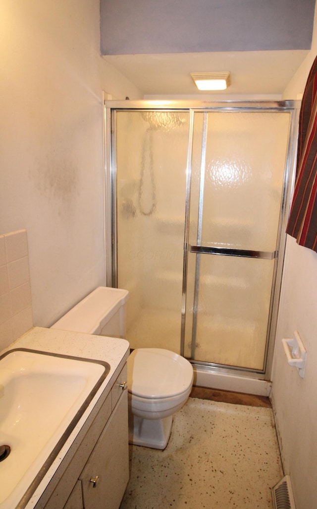 bathroom with toilet, a shower with shower door, and vanity