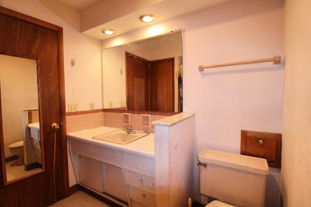 bathroom featuring toilet and vanity