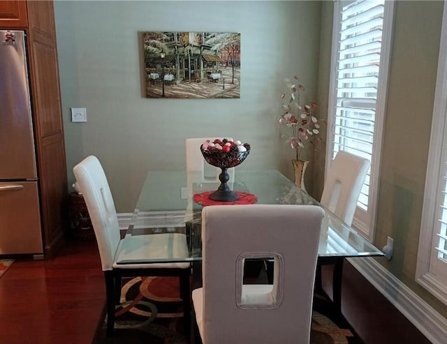 dining space with dark wood-type flooring