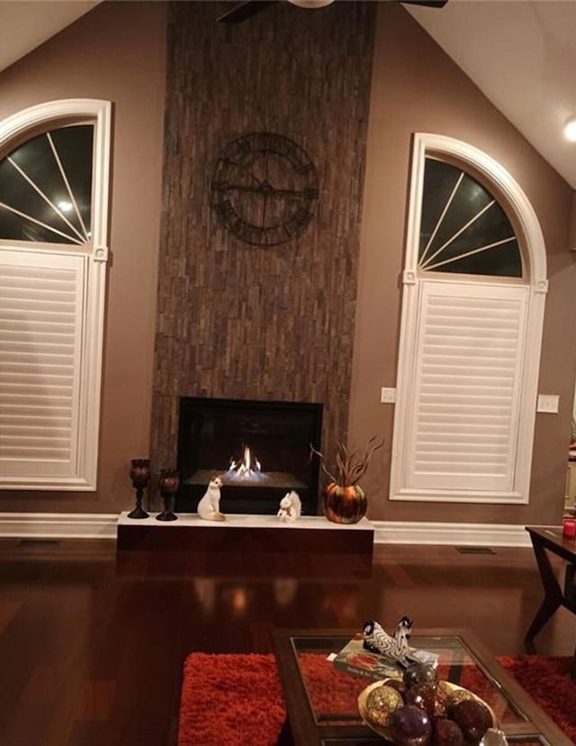 interior details with a warm lit fireplace and wood finished floors